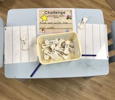 a table with some writing materials on it and a basket full of small white rocks