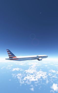 an american airlines jet flying above the clouds