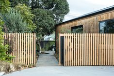 a wooden fence is next to a house