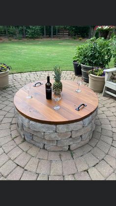 a wooden table sitting on top of a brick patio