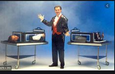 a man standing in front of two television sets