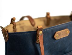 Product Description: Our Deluxe Waxed Canvas Market Tote! This is a 20 oz, heavy duty waxed canvas carry-all tote. This bag is a beauty and one tough cookie. This waxed canvas is water resistant, and our eco-friendly leather can take a beating. This size can fit up to a 15" laptop and goodies. Dimensions: 16 in wide 12.5 in tall 6 in deep Product Features: This bag comes with shoulder straps that have a 13" drop and include a detachable crossbody strap is adjustable, 37" to 46" the longest setti Leather Patch Tote Bag For Daily Use, Everyday Waxed Canvas Shoulder Bag With Leather Patch, Everyday Shoulder Bag With Reinforced Waxed Canvas, Everyday Coated Canvas Bags With Leather Patch, Everyday Waxed Canvas Bag With Reinforced Handles, Everyday Waxed Canvas Shoulder Bag With Reinforced Handles, Everyday Use Tote Bag With Leather Patch, Leather Patch Tote Bag For Everyday Use, Everyday Waxed Canvas Bag With Leather Patch