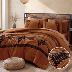 a bed with an orange comforter and pillows