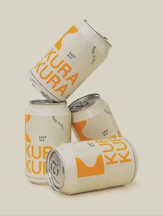 four cans of kurra are stacked on top of each other