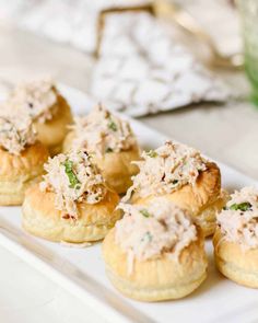 some chicken salad in puff pastry cups on a white plate