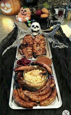 a table topped with lots of different types of food on it's trays