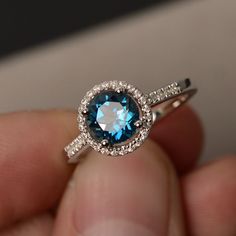 This is a gorgeous handmade creation. Its beauty is its simplicity & Elegance. The 7*7mm round cut London blue topaz is crafted in solid sterling silver and with rhodium plated. All item is sent in a beautiful gift box You can realize more lovely stuff clicking the link https://www.etsy.com/shop/knightjewelry?refshopsection_shophome_leftnav Please leave the correct address and you phone number for delivering successfully. Sterling Silver Round Topaz Promise Ring, Sterling Silver Topaz Ring With Halo Setting For Promise, Round Cut Topaz Ring With Halo Design For Gift, Round Aquamarine Birthstone Ring, Silver Topaz Ring With Round Blue Topaz, Blue Topaz Round Promise Ring, Silver Blue Topaz Ring With Round Stone, Dazzling Round Topaz Ring With Prong Setting, Dazzling Sterling Silver Topaz Ring