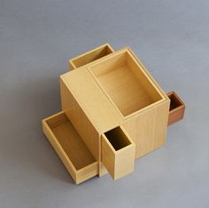 two wooden boxes are stacked on top of each other, one is open and the other is closed