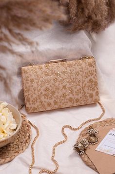 "Dynamic embellishment on the net, scintillating sequins and the true efforts of our artisans is what makes our beige sequin box clutch a true masterpiece. We assure you that you will be loaded with compliments in every party you flaunt our clutch! Embroidered front and back. Dimensions (LxB): 7.75\"x4.5\" (19.7 cm X 11.4 cm) Handle length: 47\" (120 cm) Handle drop: 23\" (58 cm) Material: Embroidered net, poly satin lining, gold metal clutch frame, gold metal sling. Features: metal lock closure, detachable metal sling." Gold Clutch Bag, Bridal Boxes, Clutch Bag Wedding, Embellished Clutch, Fancy Jewellery Designs, Bridal Bag, Embroidered Clutch, Gold Clutch, Party Clutch