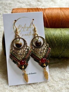 a pair of earrings sitting on top of a card