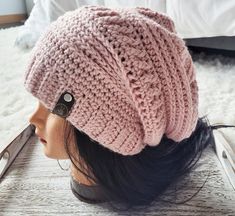 a close up of a mannequin's head wearing a knitted hat