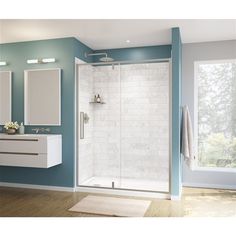 a bathroom with blue walls and white fixtures, including a walk in shower next to a sink