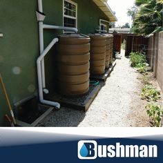 an image of a house that has water tanks on the front and side of it