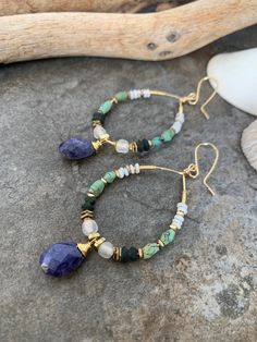 Beautiful boho style gemstone hoop earrings .., crafted with hand forged gold tone hoop frames beaded with an array of gorgeous beads .. vintage glass ...Java glass .. African Brass.. Jade .. and pretty little African Turquoise beads accented with beautiful wire wrapped Sapphire gemstones . These beauties measure 4 inches in length and are a beautiful pair !! Boho Turquoise Earrings, Unique Dangle Hoop Earrings With Natural Stones, Bohemian Hoop Earrings With Dangling Round Beads, Bohemian Dangle Hoop Earrings With Natural Stones, Bohemian Hoop Earrings With Dangling Beads, Bohemian Wire Wrapped Dangle Hoop Earrings, Bohemian Style Wire Wrapped Dangle Hoop Earrings, Unique Hoop Earrings With Natural Stones, Unique Round Hoop Earrings With Natural Stones