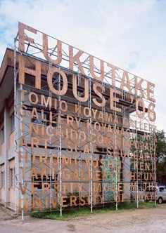 an old building with scaffolding on the front and side of it that says house