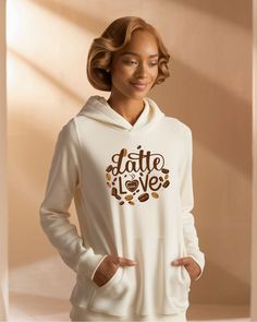 a woman wearing a white hoodie with the words latte love printed on it