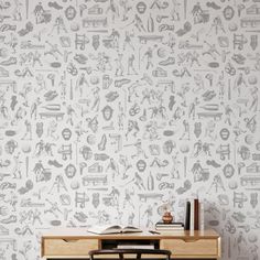 a desk with a book on top of it in front of a wallpapered background