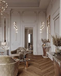 an elegant living room with white walls and wood floors, gold trimmings on the wall