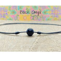 Minimalist Adjustable Choker Necklace made with a 10mm Black Onyx Stone on Strong Waterproof Nylon Cording. This striking onyx choker necklace is like many necklaces in one.  It can be worn short, as a choker, all the way to a 26 inch necklace.  The cord has 2 sliding knots which makes adjusting this necklace very easy and smooth, and you can wear it at any length to compliment all your outfits. The necklace is strong and sturdy and will hold up well to your daily activities including in the gym Necklace For Boyfriend, Stone Choker Necklace, Boyfriend Necklace, Stone Choker, Black Onyx Stone, Sliding Knot, Single Stone, Necklace For Men, Onyx Stone