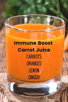 an orange juice in a glass with the words carrot juice and lemon ginger on it