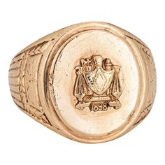 Finely detailed antique Victorian family crest signet ring (circa 1898), crafted in 10 karat yellow gold.   The oval signet mount features a family crest with the year '1898' to the base. The side shoulders feature a pretty etched foliate design. The low rise ring (3.5mm - 0.13 inches) sits comfortably on the finger.    The ring is in good condition with some wear evident. We have not cleaned it in order to preserve patina and collector value.   Particulars:  Weight: 13.5 grammes  Stones:  N/A Family Crest Rings, Family Crest, Antique Rings, Antique Victorian, Signet Ring, 10k Gold, A Family, Patina, Jewelry Rings