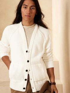 Crafted from organic cotton with a softly structured ribbed knit, this traditional style features a button front and pockets- little details that will have you longing for cabin escapes and brisk mornings.  OVERSIZED FIT: Relaxed, boxy fit with a dro Cozy Everyday Cardigan With Button Closure, Everyday Cozy Cardigan With Buttons, Cozy Everyday Cardigan With Buttons, Everyday Cotton Button Cardigan, Cotton Cardigan With Buttons For Everyday, Everyday Cotton Cardigan With Buttons, Cozy Button-up Cardigan With Pockets, Everyday Cardigan With Button Closure, White Relaxed Fit Classic Cardigan