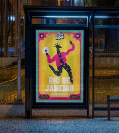 a bus stop with a poster on the side of it's glass doors at night