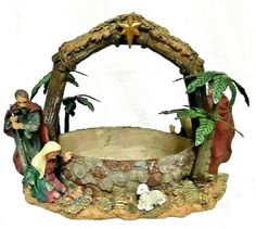 a nativity scene with figurines and palm trees