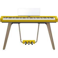 an electronic keyboard with a yellow stand and white sheet on it's back end