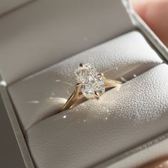 a close up of a diamond ring in a box