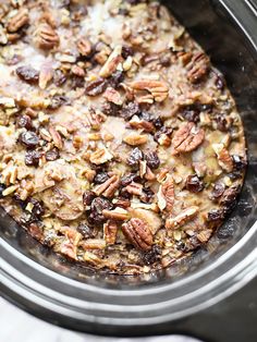 a crock pot filled with oatmeal and raisins