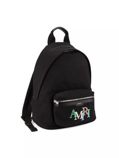 Crafted in Italy, Amiri's backpack features a vibrant staggered logo on the front pocket. Logo-engraved silvertone hardware adds the finishing touch..Top handle.Adjustable backpack straps.Zip-around closure.One main compartment.Front zip pocket.Polyester.Trim: Bovine leather.Lining: nylon.Made in Italy.ABOUT THE BRAND.Designer and California native Mike Amiri got his start making handcrafted pieces for rockstars to wear on stage. He brings the same L.A. rocker aesthetic to his eponymous label, which is known for its deconstructed jeans, leather jackets and broken-in flannels..Crafted in Italy, Amiri's backpack features a vibrant staggered logo on the front pocket. Logo-engraved silvertone hardware adds the finishing touch.Top handleAdjustable backpack strapsZip-around closureOne main compa Travel Backpack With Logo Hardware, Luxury Backpack With Logo Hardware For Everyday Use, Luxury Backpack For Everyday Use With Logo Hardware, Designer Bags With Logo Patch For Everyday Use, Luxury Everyday Backpack With Logo, Designer Backpack With Logo For Everyday Use, Modern Everyday Backpack With Logo, Designer Logo Backpack For Everyday Use, Designer Backpack With Logo For Daily Use