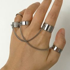 Discover the perfect fusion of goth elegance and punk rebellion with our unique Ring with Chain. This meticulously crafted piece features a robust and edgy stainless steel chain linked elegantly with a sleek ring. The adjustable band ensures a comfortable fit, making it a versatile accessory suitable for any finger. Its unisex design caters to all, embodying the true spirit of grunge and goth fashion, ideal for both everyday wear and special occasions like Halloween or themed parties. Our Finger Vampire Style, Ring With Chain, Gothic Mode, Punk Rock Jewelry, Grunge Accessories, Double Band Rings, Titanium Jewelry, Punk Inspiration, Goth Jewelry