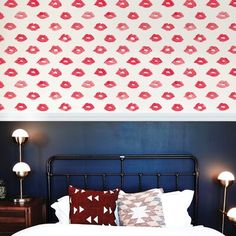 a bedroom with blue walls and red lips on the wall