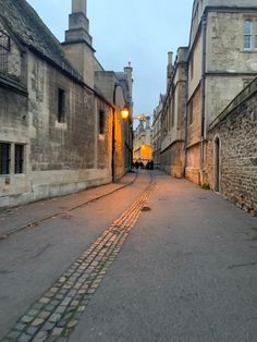 an empty street with cobblestones and old buildings