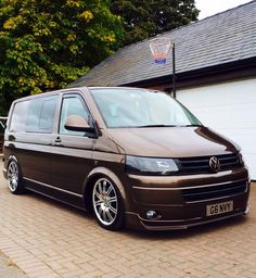 a brown van parked in front of a house