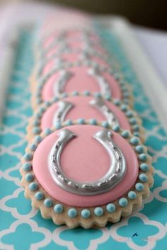 a pink and silver object sitting on top of a blue tablecloth covered in white circles