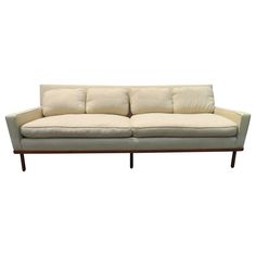 a white couch sitting on top of a wooden frame