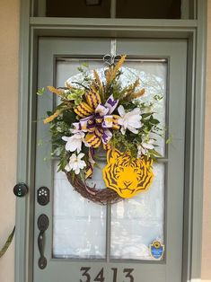 a front door with a tiger wreath on it