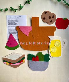 felt food cutouts are displayed on a table