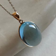 This stunning pendant is set in 14k Solid Yellow Gold with Natural Sky Blue Topaz  with utmost precision. It is a unique gemstone pendant for nearly every occasion and is completely hassle-free jewelry. ITEM DETAILS: * GEM: Sky Blue topaz * GEM Size: 13X18mm * GEM Shape: Oval * Gem Weight: 16.28 carats * Gold Purity: 14KT  * Gold Weight: 0.61 gram * Total Weight of the Pendant: 3.85 gram The Gold purity is guaranteed and it comes with an authentic 14KT gold hallmark. Since my items are handmade, Blue Drop Jewelry With Cabochon, Blue Cabochon Drop Jewelry, Blue Drop Cabochon Jewelry, Elegant Large Blue Gemstone, Gold Skies, Blue Topaz Jewelry, Handmade Jewelry Box, Blue Topaz Pendant, Topaz Jewelry