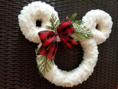 a mickey mouse wreath hanging on the side of a wall