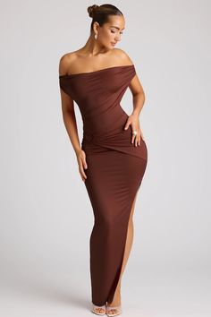 The ultimate seductive evening gown, Ravenna is made for romantic moments. Available in two warm shades, Ravenna is cut from a premium slinky jersey that¡¯s stretchy and sculpting, and features a bust-flattering plunging cowl neckline. Its gorgeous ruched detailing and heart-shaped metal adornments are sure to attract admirers.   Plunge cowl neckline  Twisted racer back  Ruched waistband  Heart-shaped metal hardware detailing  Column skirt with thigh-high split  Pull-on design  Maxi length, side seam approx. 128 cms based on a US Size 4  Product code: 8067   We do our best to ensure that our photos are as true to colour as possible. However, due to inconsistencies in monitors, digital photography and production variations, we cannot guarantee that the colour you see on your screen accurate Seductive Style Outfit, Black Backless Dress, Column Skirt, Romantic Moments, Cowl Neckline, Embellished Dress, Ruched Dress, Classy Dress, Corset Dress