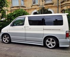 a white van parked in front of a building