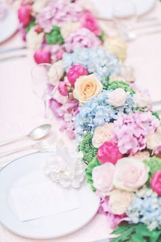 a vase filled with pink and red flowers on top of a table