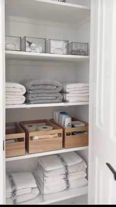 an organized closet with folded towels and linens