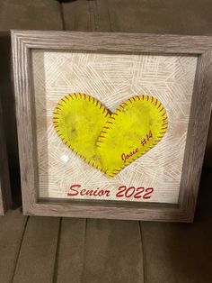 two framed baseballs with the words senior 2012 written in red and yellow on them