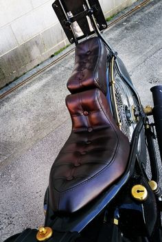 a motorcycle seat sitting on the back of it