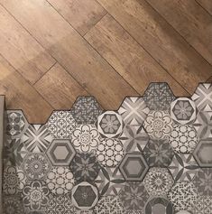 the floor is made up of hexagonal tiles and wooden floors, which are lined with wood planks