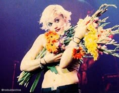 lady with flowers in her arms on stage